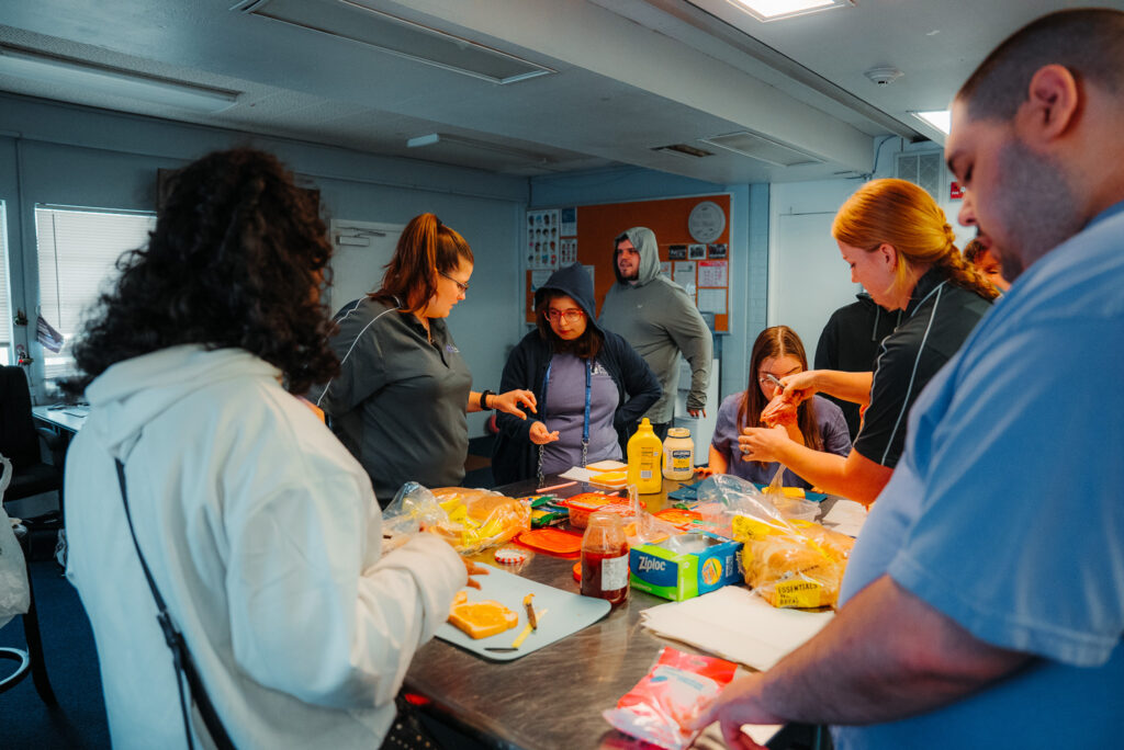 Focus Academy students and staff preparing food together around a classroom table