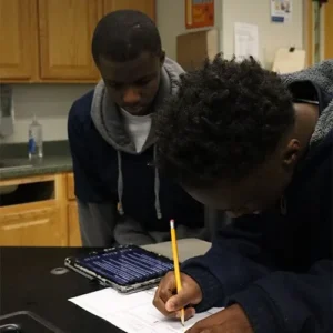 Two Focus Academy students working together on a classroom research project.