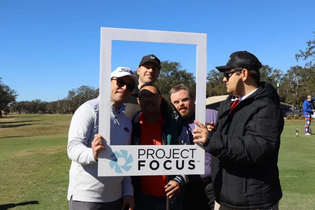 Foursome with the Project Focus frame on the course