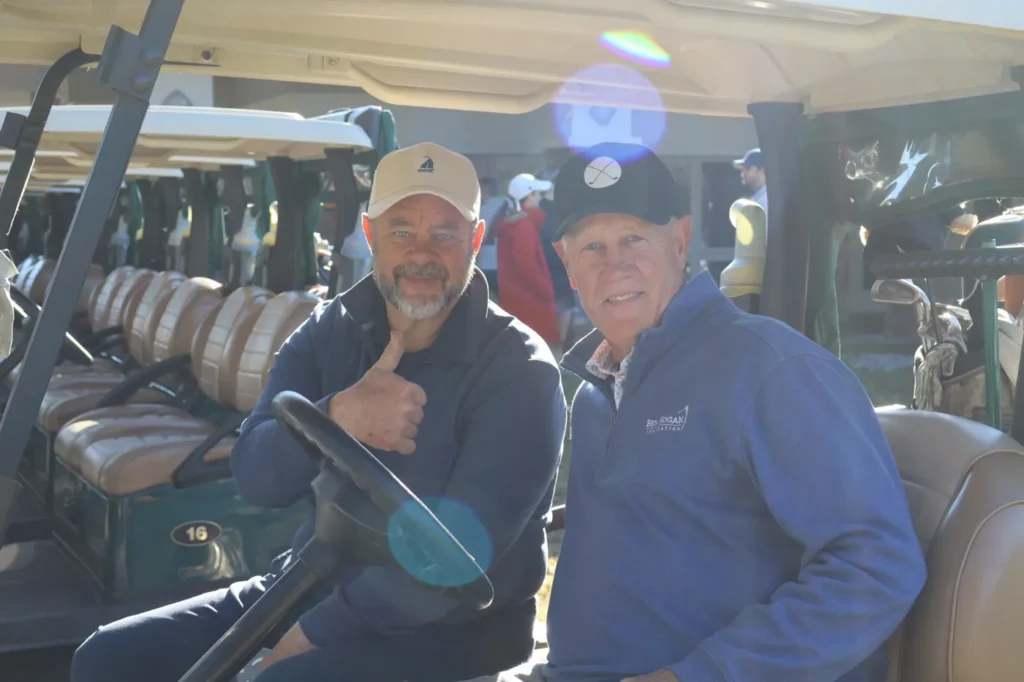 Two golfers in a cart before the round