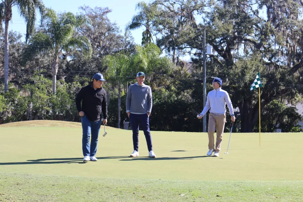 Golfers approaching the green