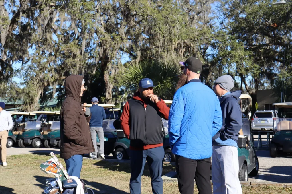 Players talking near the carts before tee off